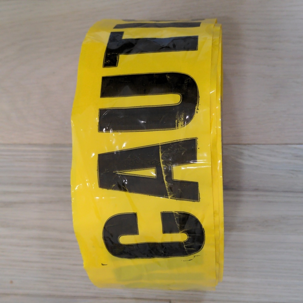 Large spool of caution tape yellow